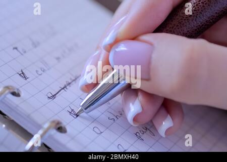 Motivation, management, productivity, success, planning, reminder, goals concept. Woman hand putting mark on check boxes of to do list in personal Stock Photo