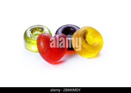 Multicolored round and heart shaped lollipops lying on a white background Stock Photo