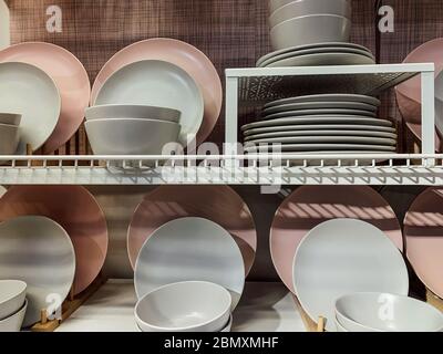lots of white pink dishes for food on kitchen Stock Photo