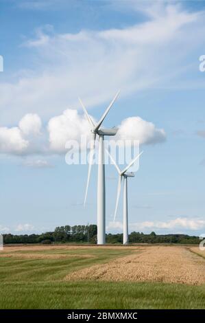 Wind turbines in a field with clear sky Stock Photo - Alamy