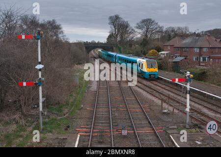 Arriva trains Wales Alstom class 175 Coradia train 175112 at Helsby with upper quadrant mechanical railway signals -  north Cheshire railway line Stock Photo