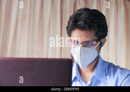 Man working from home. Using laptop. Stock Photo