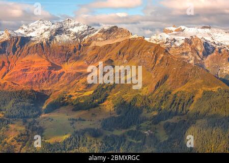 Panoramic view of Swiss Alps mountain snow peaks, Jungfraujoch, ski resort, Switzerland, green and red terrian Stock Photo