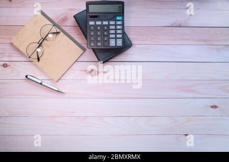 Top view of notepad, calculator and pen on table  Stock Photo