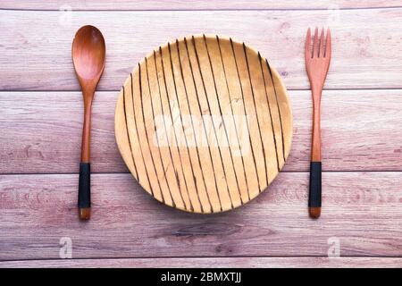 Clean empty plate with knife and fork on table  Stock Photo