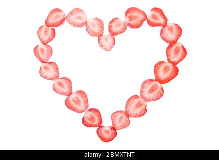 Red heart shape made of delicious strawberry halves isolated on white background as a design element for love concept - Valentine's Day and Mother's D Stock Photo