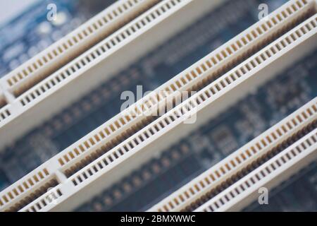 Closeup on empty pci or ram slots on a modern blue motherboard. Electronics, technology, pc components concept Stock Photo