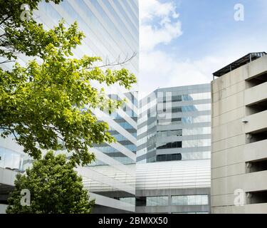 Modern workplace of the new age, imposing and architectural with reflective glass against the cloud-filled sky Stock Photo
