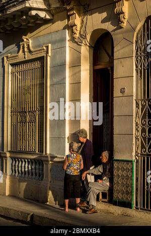 Local people gathered in front of their house, Santa Clara, Cuba Stock Photo