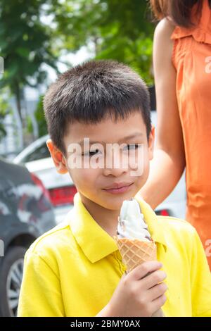 Asian boys are eating ice cream. Stock Photo