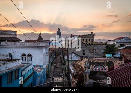 Atmospheric cityscape with Calle Heredia, and Cathedral tower in distance at dusk, Santiago de Cuba, Cuba