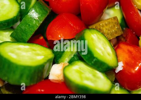 Vegetable salad sliced tomatoes, cucumbers, onions and pickles. Close up. Healthy food, fitness diet Stock Photo
