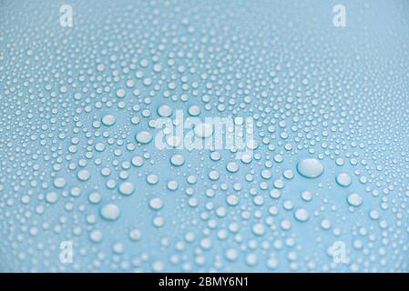 Close-up drops of water on blue surface, raindrops, background or texture Stock Photo
