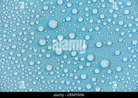 Close-up drops of water on blue surface, raindrops, background or texture Stock Photo