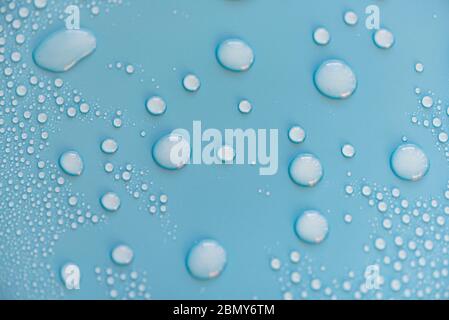 Close-up drops of water on blue surface, raindrops, background or texture Stock Photo