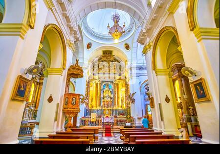 CADIZ, SPAIN - SEPTEMBER 24, 2019: Interior of small Iglesia del Rosario (Rosario Church) with beautiful gilden Altar with sculpture of Madonna, on Se Stock Photo