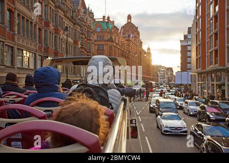 Red bus open deck tour down Brompton Road Stock Photo