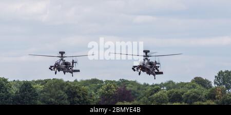 Army Air Corps WAH-64D Apache pair coming into land at RAF Fairford, Gloucestershire in July 2017. Stock Photo