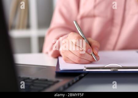 Closeup, female hands taking notes with pen office Stock Photo