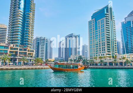 DUBAI, UAE - MARCH 2, 2020: Dubai Marina is popular tourist spot with many different attractions, such as dhow boat cruises, on March 2 in Dubai Stock Photo