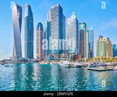DUBAI, UAE - MARCH 2, 2020: Explore quarters of skyscrapers, located around Dubai Marina and famous for unique design, such as Cayan Tower or the heig Stock Photo