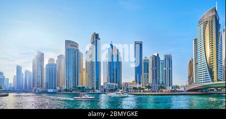 DUBAI, UAE - MARCH 2, 2020: Panorama of  Dubai Marina with canal, bridge, forest of modern skyscrapers, Park Island towers and floating yachts, on Mar Stock Photo