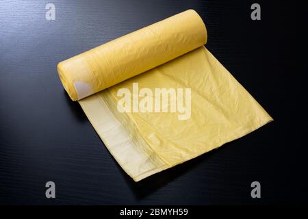 Yellow garbage bags on a wooden table Stock Photo