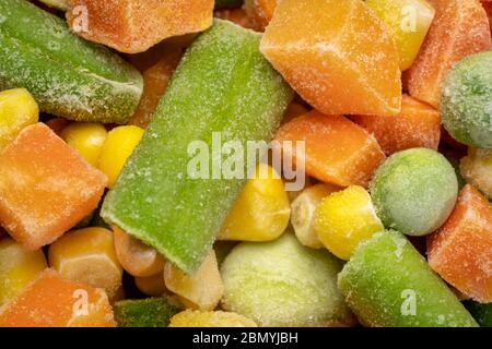 closeup background and texture of frozen vegetable medley - carrots, peas, green beans, corn, and baby lima beans Stock Photo