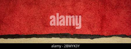 red, black and beige - abstract landscape created with colorful sheets of handmade textured paper, long web banner Stock Photo