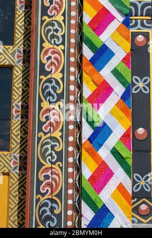 Bhutan, Punakha. Sopsokha village, Gateway to the Chimi Lhakhang monastery aka Fertility Temple. Detail of traditional colorful architecture. Stock Photo