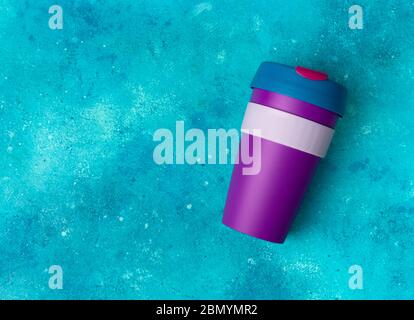 Reusable coffee or tea colorful cup mug on turquoise background Stock Photo