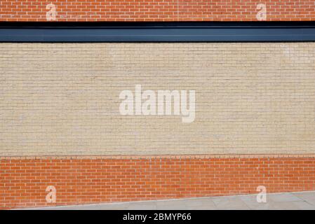 The Side of a Building Brick Wall, Showing the Red and Yellow Stock Clay Material. Stock Photo
