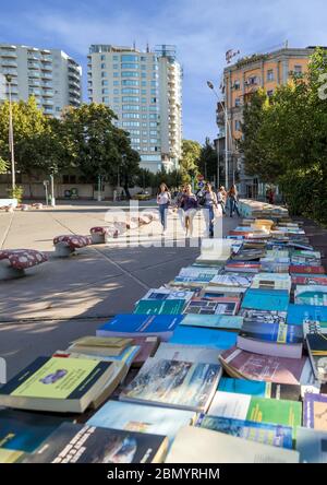 Open-air book sales on the bridge over canal at Ibrahim Rugova street. Tirana city center,  Albania. Stock Photo