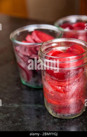 Pack the sliced beets into the canning jars.  This is called 'hot packing'!  Pack the jars fairly tightly, but be sure to leave ½-inch of space at the Stock Photo