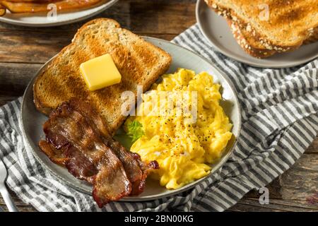 Homemade American Scrambled Egg Breakfast with Bacon and Toast Stock Photo