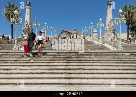 15 Aug 2018. steps and architectural details at marseille saint charles train station showing passengers walking down the stairs Stock Photo