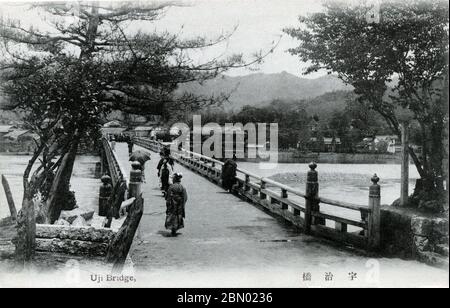 [ 1910s Japan - Traditional Japanese Bridge in Uji, Kyoto ] —   People walking across Uji-bashi Bridge (宇治橋) in the historic town of Uji (宇治) in Kyoto Prefecture, sometime between 1907 and 1918.  Uji-bashi Bridge is considered one of Japan's three most ancient bridges. It is believed to have been first built in 646. Over the centuries, the bridge has figured in countless poems, novels and paintings.  20th century vintage postcard. Stock Photo