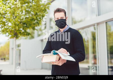 Student during covid-19 cannot enter closed university building Stock Photo