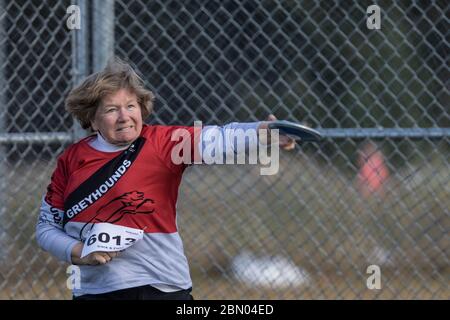 Senior Ladies Discus Throw competition. 60 year old age group, jusr releasing Stock Photo