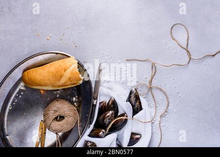 Mussels or clams, shellfish on light background, text space. Overhead view. Stock Photo