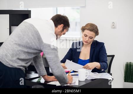 A team of young office workers working hard in the office Stock Photo