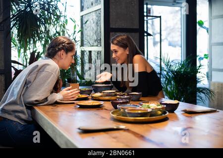 Good looking girls having a lunch in a fancy cafe, girls chattin Stock Photo