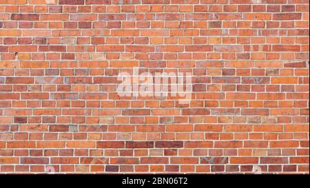 Reddish Brick Wall of an Old Building. Background of a Wall With Old Stones. Old Wall of a Church Stock Photo