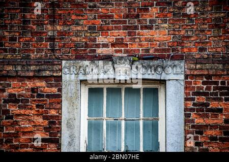 Closeup of windows of brick built Grade II listed King Edward VI Grammar School, Spilsby, Lincolnshire in bad state of repair Stock Photo