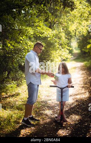 Portrait of happy sporty family of father and preteen girl during training  outdoors Stock Photo - Alamy