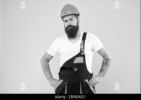 miner wear helmet for safety. expert in building. brutal male worker with beard. he is just artisan. choose your occupation. construction engineer in work uniform. man builder in hard hat. Stock Photo