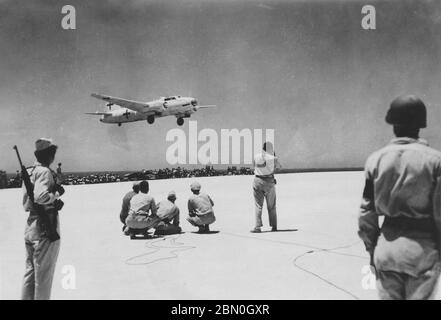 [ 1945 Japan - Japanese Surrender WWII ] —   A specially-marked Japanese Mitsubishi G4M 'Betty' bomber lands on the US held island of Iejima in Okinawa Prefecture shortly after noon on August 19, 1945 (Showa 20).  The plane carried Japanese emissaries en route to Manila to meet with General Douglas MacArthur's staff to work out the details of Japan's surrender marking the end of WWII.  20th century gelatin silver print. Stock Photo