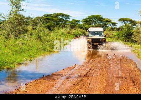 Jeep crosses a ford with water, Serengeti National Park, Tanzania