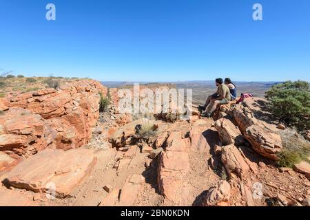 Two hikers sitting on top of Mt Gillen, Alice Springs, Northern Territory, NT, Australia Stock Photo