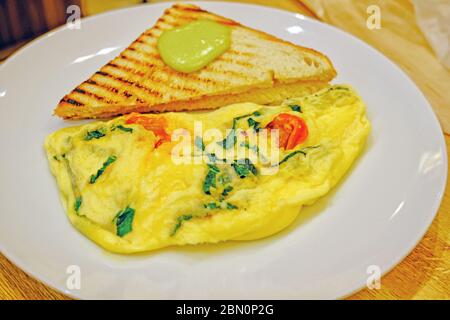 scrambled eggs omelette with fresh herbs tomatoes basil greek